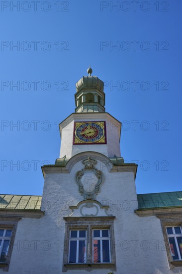 Tower clock on a historic building under a clear blue sky. Impressive baroque architecture, brewhouse am Schloss, Regensburg, Bavaria, Germany