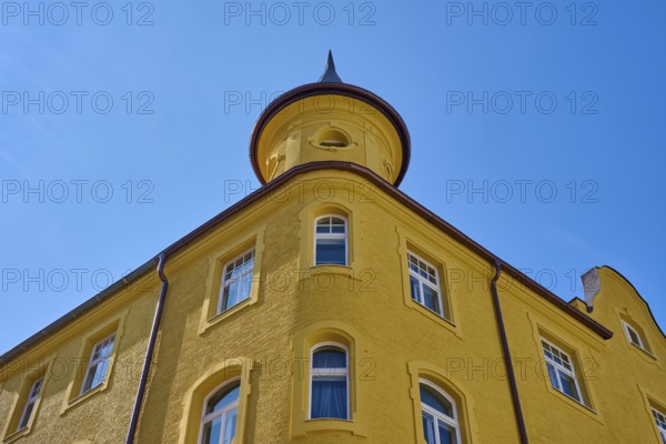 Yellow building with round tower and windows in front of a clear sky, Regensburg, Bavaria, Germany