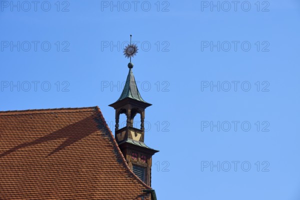 Historic rooftop with tower and weather vane under a clear sky, Regensburg, Bavaria, Germany