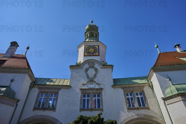 Historic building with tower and clock under a radiant sky. Baroque details and symmetrical design, brewhouse am Schloss, Regensburg, Bavaria, Germany