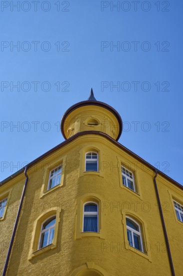 Yellow building with round tower and windows in front of a clear sky, Regensburg, Bavaria, Germany