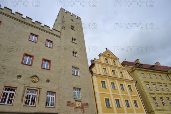 Historic buildings with medieval tower under a cloudy sky in Regensburg, Regensburg, Bavaria, Germany