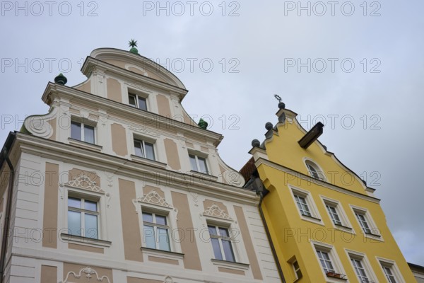 Detailed view of decorated facades of historic buildings under a cloudy sky, Regensburg, Bavaria, Germany