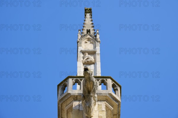 Detail of a Gothic spire with sculptures in the blue sky, St Peter's Cathedral, Regensburg, Bavaria, Germany