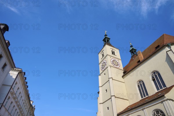 Gothic-style church tower and building under a bright blue sky, flanked by other buildings, Neupfarrkirche, Regensburg, Bavaria, Germany