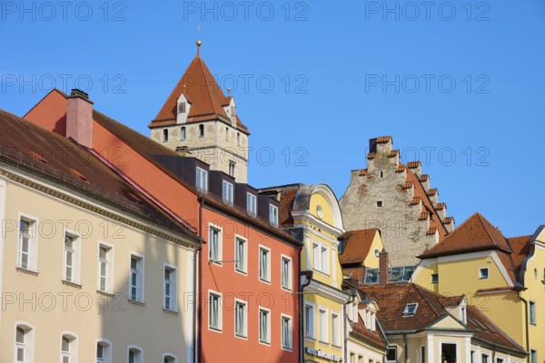 Various colourful facades with a tower and clear sky, Regensburg, Bavaria, Germany