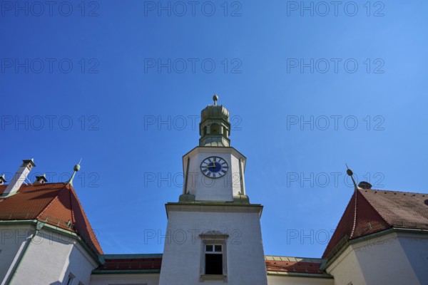 Tower with clock on a historic building. Blue roof and baroque details against a clear sky, brewhouse am Schloss, Regensburg, Bavaria, Germany