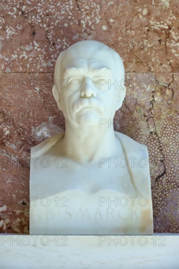 Marble bust of Bismarck against a red background, conveying seriousness and historical significance, Walhalla, Donaustauf, Regensburg, Bavaria, Germany