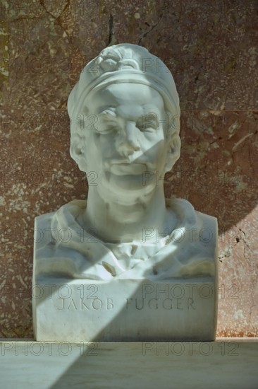 White marble bust of Jakob Fugger in front of a reddish wall, Walhalla, Donaustauf, Regensburg, Bavaria, Germany