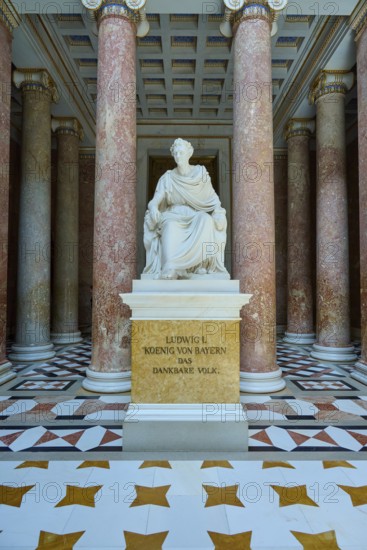 White statue of Ludwig I, surrounded by red marble columns and magnificent floor pattern, Walhalla, Donaustauf, Regensburg, Bavaria, Germany