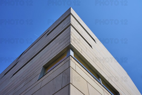 Modern building with concrete façade against a blue sky in minimalist perspective, Regensburg, Bavaria, Germany