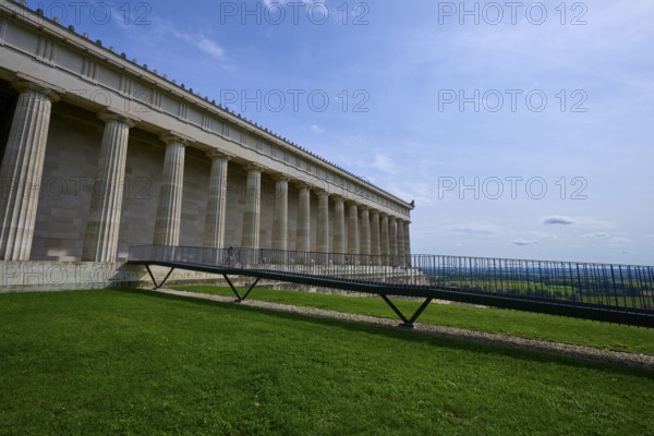 Historic columned building next to a green area under a clear blue sky, Walhalla, Donaustauf, Regensburg, Bavaria, Germany