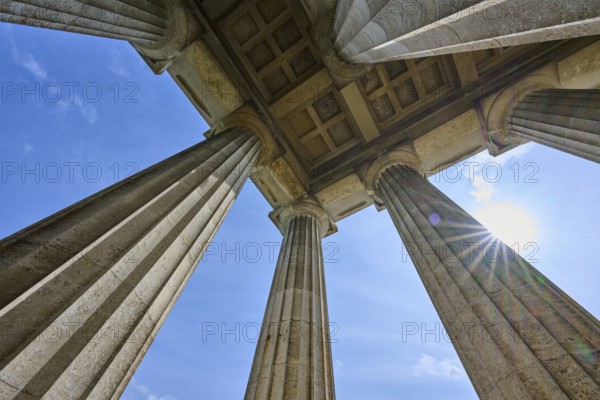 Imposing columns against a bright blue sky with a view of the sun, Walhalla, Donaustauf, Regensburg, Bavaria, Germany