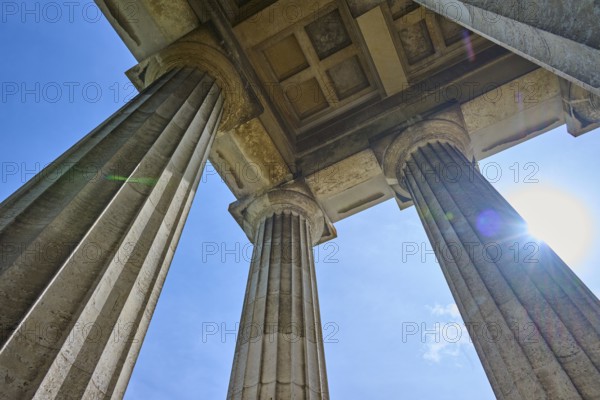 Three massive columns rise up against the blue sky, seen from below, Walhalla, Donaustauf, Regensburg, Bavaria, Germany