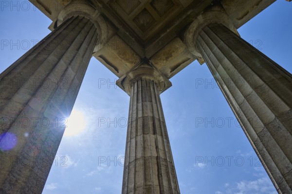 Majestic columns under a bright blue sky, seen from a low perspective, Walhalla, Donaustauf, Regensburg, Bavaria, Germany