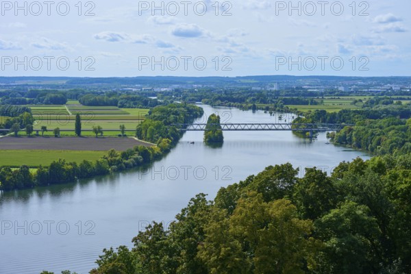 A tranquil river landscape with bridge and trees under a cloudy sky, Walhalla, Donaustauf, Danube, Regensburg, Bavaria, Germany