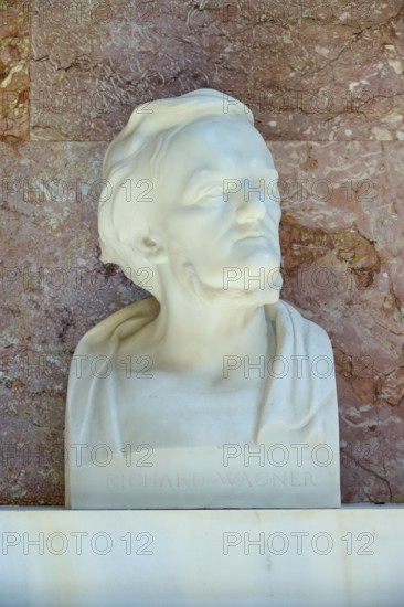 Artistic marble bust of Richard Wagner with an expressive face against a red background, Walhalla, Donaustauf, Regensburg, Bavaria, Germany