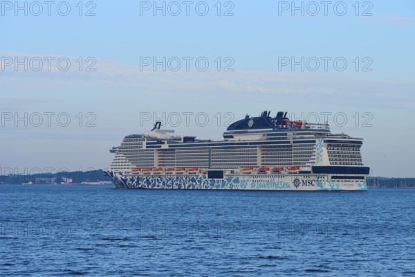 A large cruise ship, MSC Euribia, on the sea with blue sky and clouds, Heikendorf, Plön district, Kiel Fjord, Schleswig-Holstein, Germany