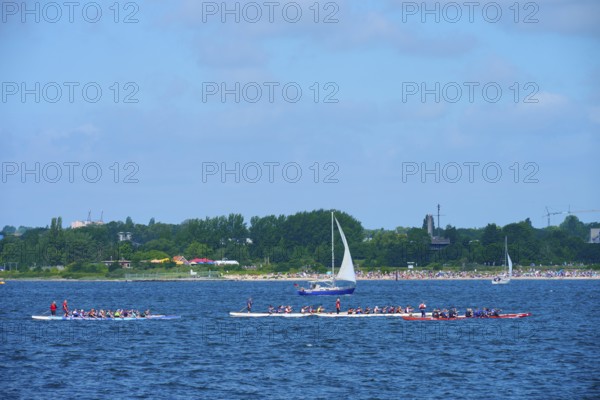 Canoeist and sailing boat on the sea in sunny weather, Heikendorf, Plön district, Kiel Fjord, Schleswig-Holstein, Germany