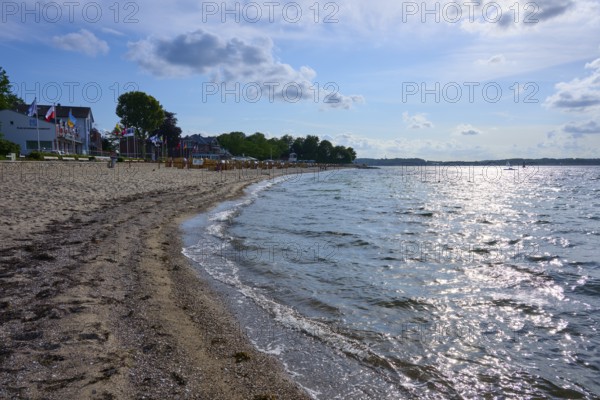 Sandy beach beach with undulating sea under a blue sky, the sun reflected on the water, Heikendorf, Plön district, Kiel Fjord, Schleswig-Holstein