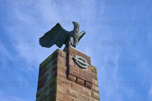 Close-up of an eagle on a stone monument in front of a clear blue sky. Radiance of majesty and grace, submarine memorial, Heikendorf, Plön district, Kiel Fjord, Schleswig-Holstein, Germany