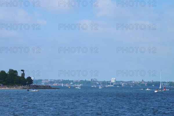 Sea view with sailing boats and a distant city of Kiel on the horizon, Heikendorf, Plön district, Kiel Fjord, Schleswig-Holstein, Germany