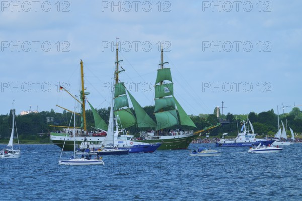 A large sailing ship with green sails Alexander von Humbold 2 and other boats on blue water, Windjammer Parade Kiel 2025, Heikendorf, Plön district, Kiel Fjord, Schleswig-Holstein, Germany