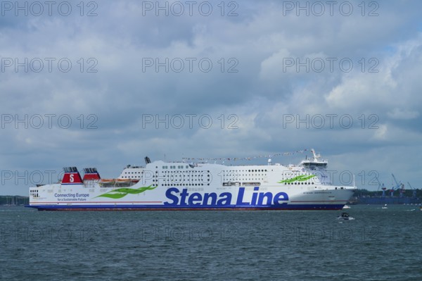 Stena Line ferry sails calmly across the sea under a dramatic, cloudy sky, Windjammer Parade Kiel 2025, Heikendorf, Plön district, Kiel Fjord, Schleswig-Holstein, Germany