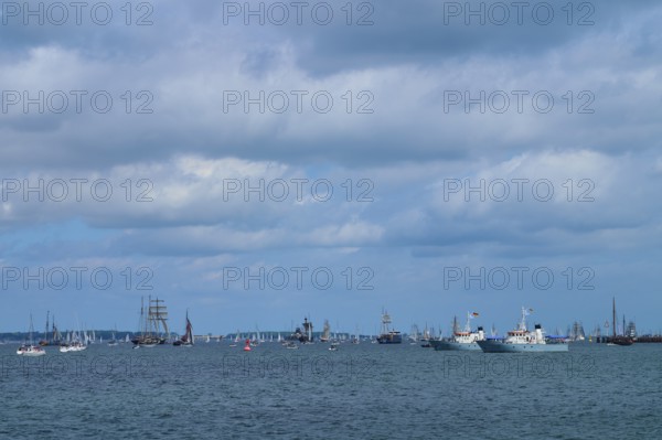 Yachts and sailing ships join each other on the sea under a cloudy sky, Windjammer Parade Kiel 2025, Heikendorf, Kreis Plön, Kieler Förde, Schleswig-Holstein, Germany