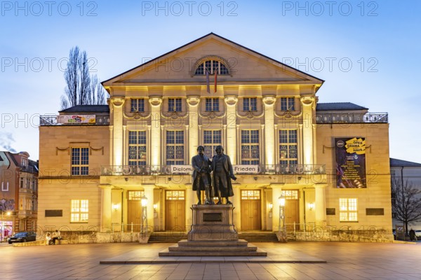 The German National Theatre with the Goethe and Schiller Monument at dusk, Weimar, Thuringia, Germany