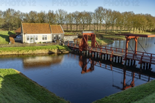 Moat and drawbridge of the inhabited former Bourtange fortress, Groningen, Netherlands