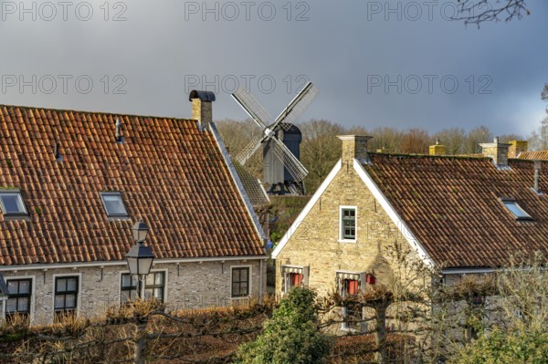 Traditional houses and windmill of the inhabited former fortress of Bourtange, Groningen, Netherlands