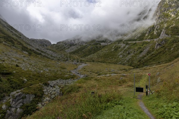 Fog, hiking trail at the Gotthard Pass, right pass road, Hospental, Uri, Switzerland
