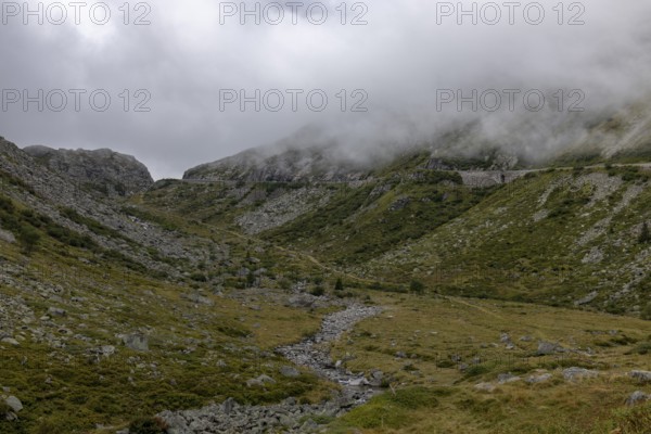 Fog, hiking trail at the Gotthard Pass, right pass road, Hospental, Uri, Switzerland