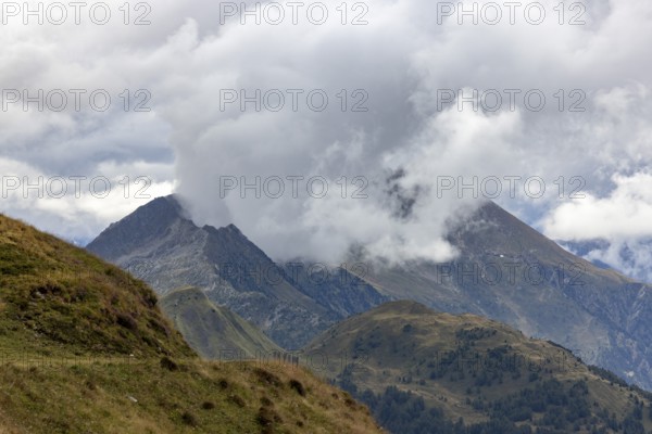 View over Passo Scimfuss to Pizzo del Sole in the clouds, Airolo, Ticino, Switzerland