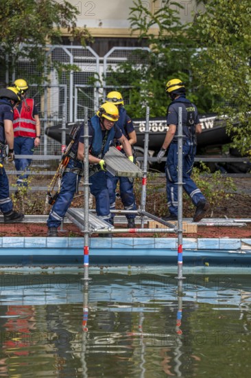 Emergency services practise the construction of footbridges, which are used e.g. in the event of flooding, at an old swimming pool, large-scale exercise FÜLEX25, of the THW, Federal Agency for Technical Relief, North Rhine-Westphalia, on 4 weekends over 3500 volunteers from the 127 North Rhine-Westphalia local organisations practise many different deployment scenarios from the areas of disaster control and civil defence