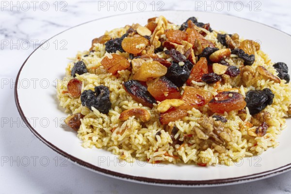 Rice dish, with the addition of dried fruits, nuts and spices of Middle Eastern cuisine, homemade, no people