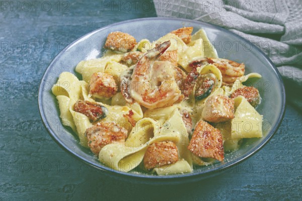 Papardelle pasta in creamy sauce with seafood, homemade, no people