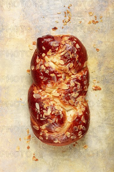 Braided, sweet bread pie, with sliced almonds, breakfast, braided bread, brioche, on a light background, top view, no people