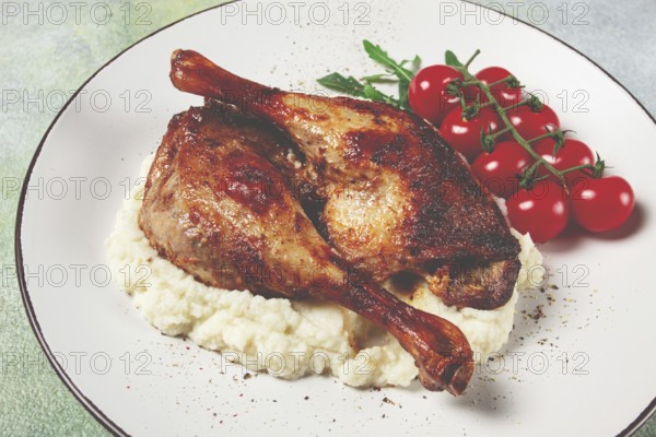 Fried duck shank, cauliflower puree, cherry tomatoes, homemade, no people
