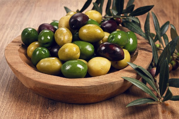 A mixture of olives, varieties of chalkidiki, Verdi giganti and Kalamata, in a bowl, top view, no people