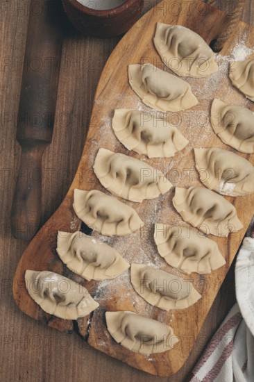 Gyoza cooking, on a cutting board, gyoza Japanese dumplings, top view, selective processing, raw gyoza