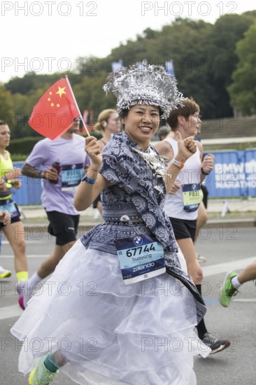 A runner with the flag of the People's Republic of China on the Great Star at the 51st BMW Berlin Marathon 2025 on 21 September 2025