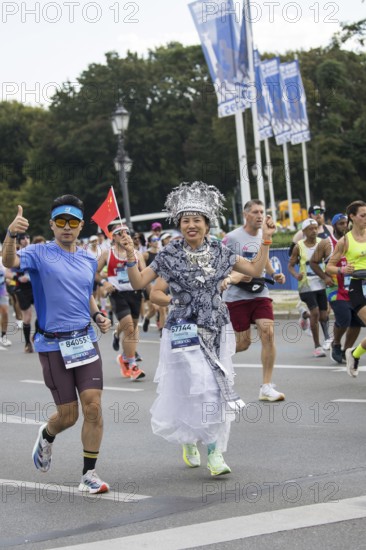 A runner with the flag of the People's Republic of China on the Great Star at the 51st BMW Berlin Marathon 2025 on 21 September 2025