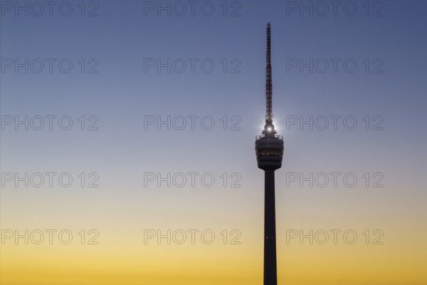 Close-up view of a television tower in front of a colourful sky at sunrise, Stuttgart, Baden-Württemberg, Germany