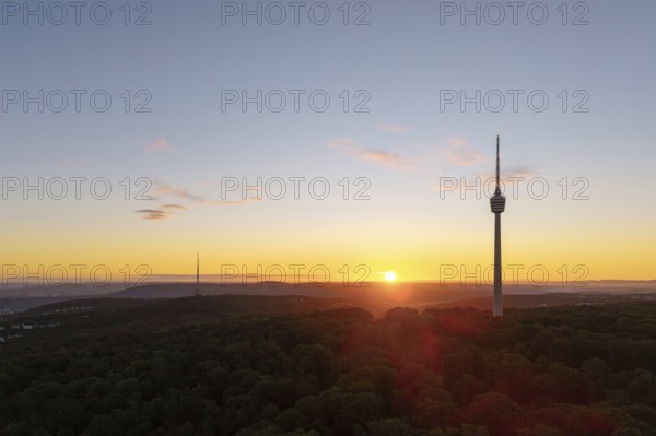 A new day begins with a television tower rising above a forest at sunrise, Stuttgart, Baden-Württemberg, Germany