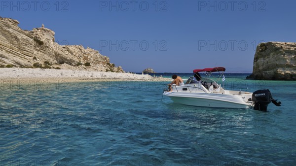 Motorboat drifting in the clear blue sea in front of a rocky coastline, White Cliffs, White Beach, Makri Aspronisi Island, Natura 2000 area, boat trip, Aspronisi, Lipsi, Dodecanese, Greek Islands, Greece