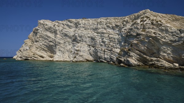 An imposing cliff rises above the blue sea under a bright sky, White Cliffs, White Beach, Makri Aspronisi Island, Natura 2000 area, boat trip, Aspronisi, Lipsi, Dodecanese, Greek Islands, Greece