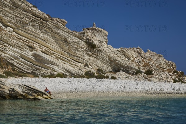 A rocky coastline with clear views of turquoise waters and a blue sky, White Cliffs, White Beach, Makri Aspronisi Island, Natura 2000 area, boat trip, Aspronisi, Lipsi, Dodecanese, Greek Islands, Greece