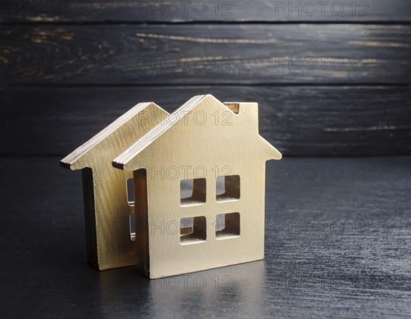 A collection of small model houses with cozy lighting, creating a warm and inviting atmosphere, AI generated